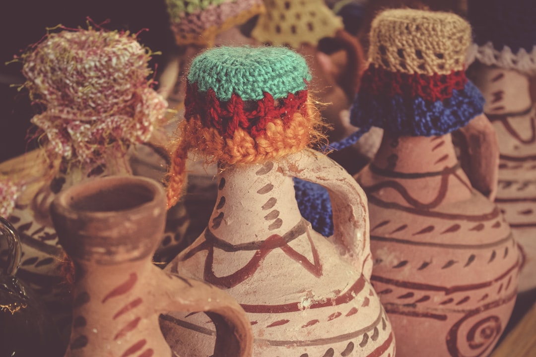Photo by Jametlene Reskp a group of vases with colorful designs